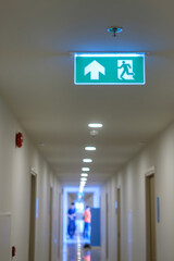 Fire Emergency exit sign on the wall background inside building. Safety concept