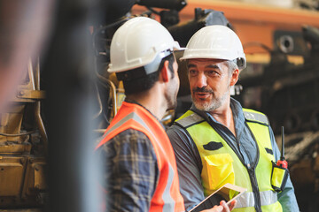 Obraz premium professional industrial engineers in hard hats. working at heavy industry manufacturing factory, man worker in an construction industrial job, maintenance service check for safety first concept