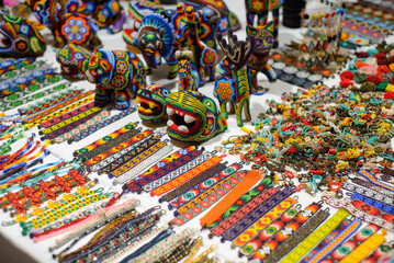 Fototapeta na wymiar Accessories made with multicolored chaquira. Mexican handicrafts made with colorful stones.