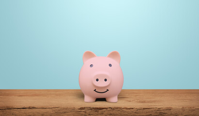 Piggy bank on a wooden table with blue background. saving money and invest concept.