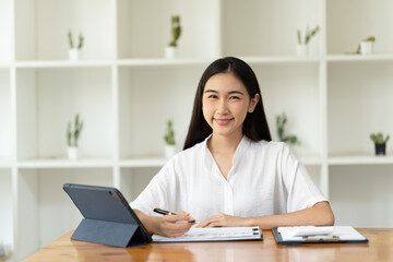 Asian woman working with laptop in her office. business financial concept.