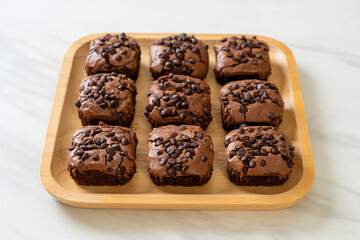 dark chocolate brownies topped by chocolate chips
