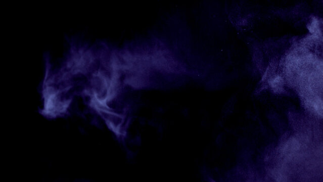 Scene glowing violet, purple smoke. Atmospheric smoke, abstract color background, close-up. Royalty high-quality free stock of Vibrant colors spectrum. violet mist or smog moves on black background