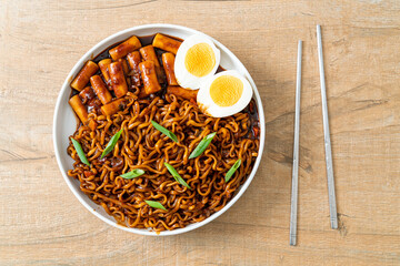 Jjajang Rabokki - Korean instant noodles or Ramyeon with Korean rice cake or Tteokbokki and egg in...