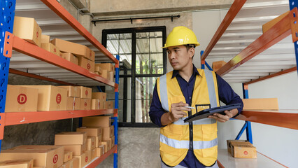 Asian man managing warehouse worker man holding tablet in warehouse Logistics network distribution...