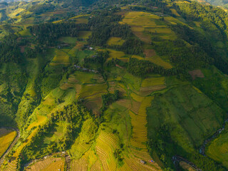 Aerial view of golden rice terraces at Mu cang chai town near Sapa city, north of Vietnam. Beautiful terraced rice field in harvest season in Yen Bai, Vietnam
