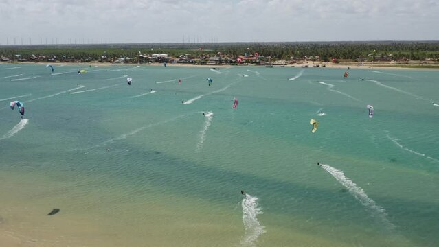 Many kite surfers on the water at Ilha do Guajiru, Brazil, drone view. 