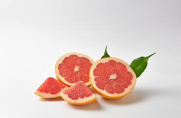 Grapefruit halves and quarters on a white background. Vitamin C.