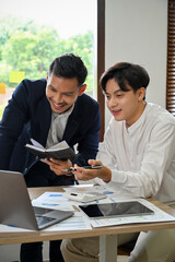 Portrait, Two happy and cheerful Asian businessmen brainstorming and working together