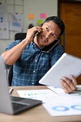 Busy and hardworking Asian businessman receives multiple phone calls in the same time