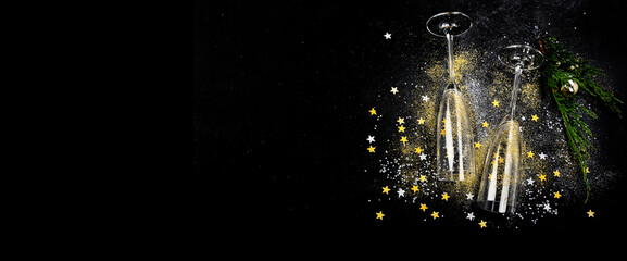 Obraz na płótnie Canvas Two glasses of champagne with glitter and splash. Celebration theme.