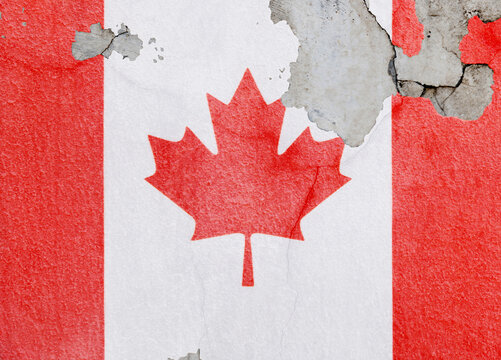 Canadian flag on old wall with peeling paint