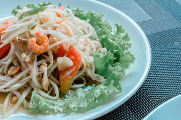 The image of Papaya Salad with Blue Crab is beautifully placed on the dining table in restaurants, seafood, food and tourism.