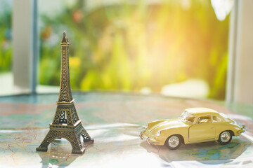 Image travel concept, car toys and Eiffel Tower Model on map