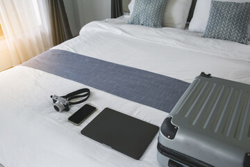 Suitcase or luggage bag with camera and notebook in a modern hotel room - relaxing time, holidays, weekend and traveling concept. copy space.