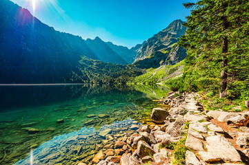 Fototapeta na wymiar Tatra National Park in Poland. Famous mountains lake Morskie oko or sea eye lake In High Tatras. Five lakes valley