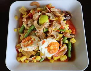 Papaya Salad with boiled corn, salted duck egg, dried shrimp, cowpea ,cashew nut and 
salted crab. Popular spicy Thai Food or Som Tam. 