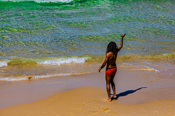 a man dancing on the beach