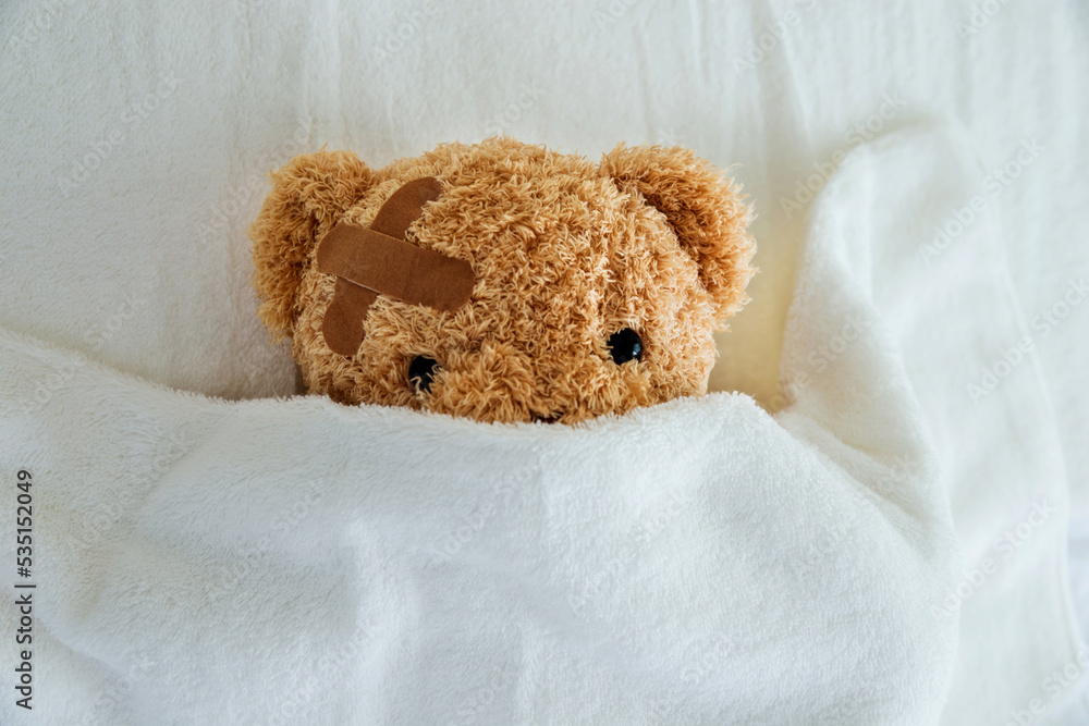 Canvas Prints Teddy bear with bandaged head ill in bed