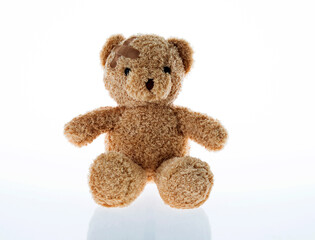 Teddy bear with bandages isolated on white background
