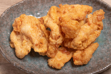 Breaded chicken fillet and batter. Delicious crunchy, hearty meat appetizer.In a ceramic dish.