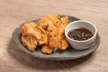Breaded chicken fillet and batter. Delicious crunchy, hearty meat appetizer.In a ceramic dish.