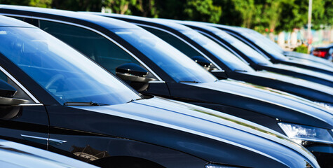 Group of black cars parked in a row