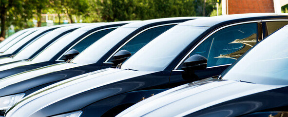 Group of black cars parked in a row