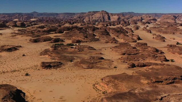 Aerial view overlooking raw desert nature and sandstone cliffs, in Hegra, Saudi Arabia