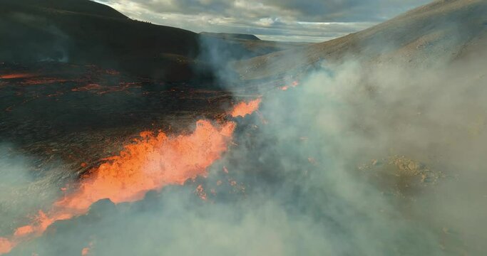 Cinematic Fpv drone shot through Volcanic smoke over spewing magma cones in Iceland