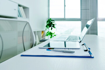 Workspace desk with laptop and digital tablet