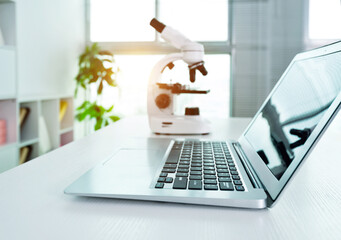 Laptop and microscope on a table