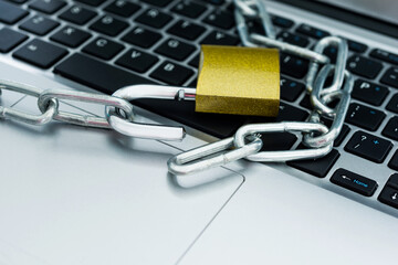 Close up of laptop with chain and padlock