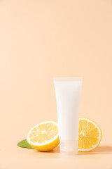 Сosmetic jar with lemon slices on beige background. Organic cosmetic products with vitamin C. Skin care concept, herbal cosmetics on beige background