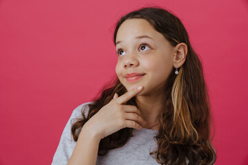 White preteen girl wearing t-shirt smiling and looking aside