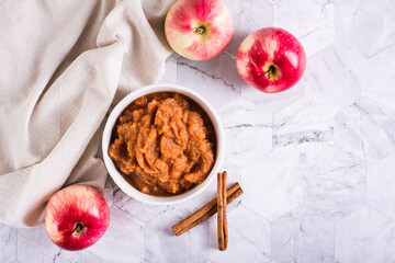 Applesauce with cinnamon in a bowl and fresh fruit on the table. Organic food. Top view