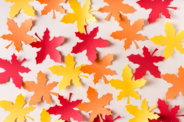 Beautiful background of cut maple leaves from craft paper. Autumn decoration.