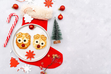 Christmas deers face pancake with raspberry for kids baby children breakfast dinner. xmas food