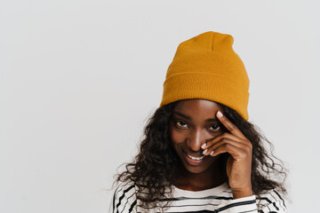 Portrait of young beautiful smiling happy african woman touching face