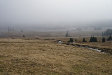 Morning autumn fog in abandoned village Chaloupky in Ore Mountains, Czech Republic