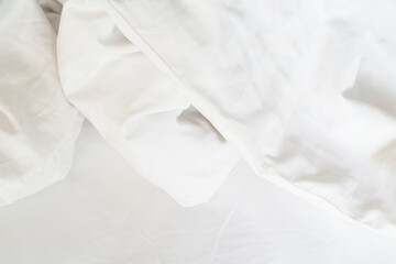 Obraz premium Unmade bed; wrinkled pillowcases, bed sheet and duvet