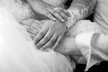 Closeup black and white photo of bride hands with ring