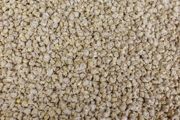 Closeup view of granules - food for broilers at chicken farm.