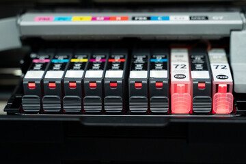 A stack of color printer cartridges