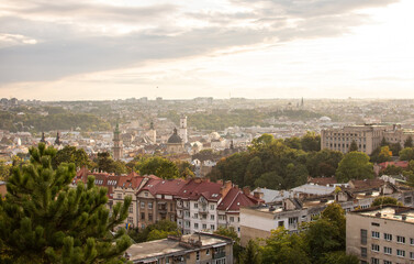 Top view of the roof of an old European city - Lviv. Old architecture, old metal rusted roofs at sunset.