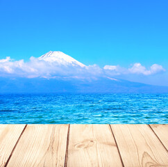 Beautiful sacred Mount Fuji, lake and old wooden plank, Japan. Empty wooden table top and scenic with pond and Fujiyama volcano