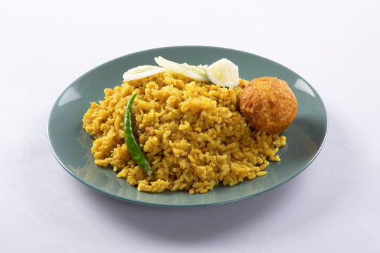 Bengali dish khichdi or khichuri made from a combination of lentils and rice along with Indian spices. in a mud bowl isolated on white background Bengali dish khichdi or khichuri.