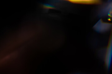 Blur colorful rainbow crystal light leaks on black background. Defocused abstract multicolored retro film lens flare bokeh analog photo overlay or screen filter effect. Glow Vintage prism colors