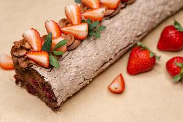 Homemade strawberry shortcake cake roll with cream cheese whipped cream, perfect summer season dessert served on rustic wooden board. Chocolate roll with strawberries. Swiss roll cake cream.