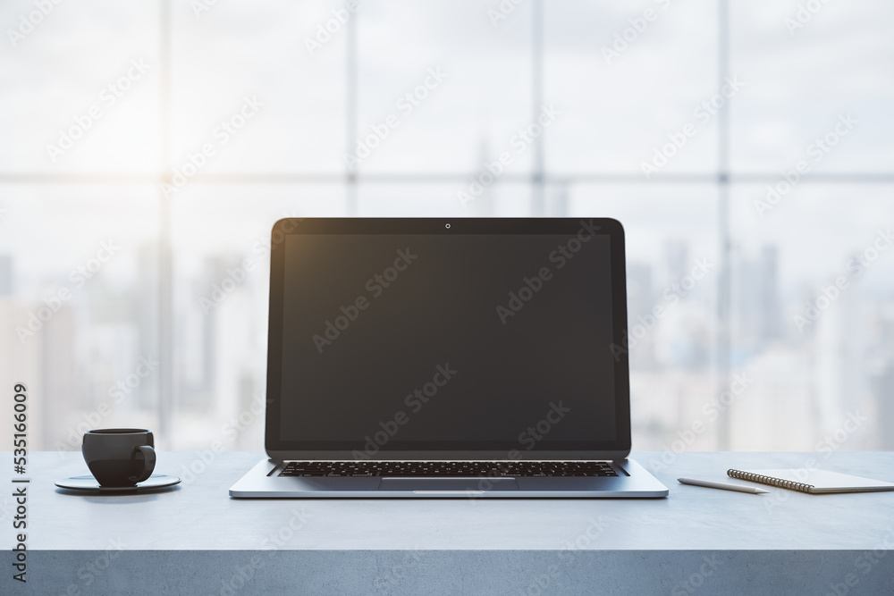 Poster close up of empty laptop computer on concrete desktop with coffee cup, notepad, pen, mock up place o